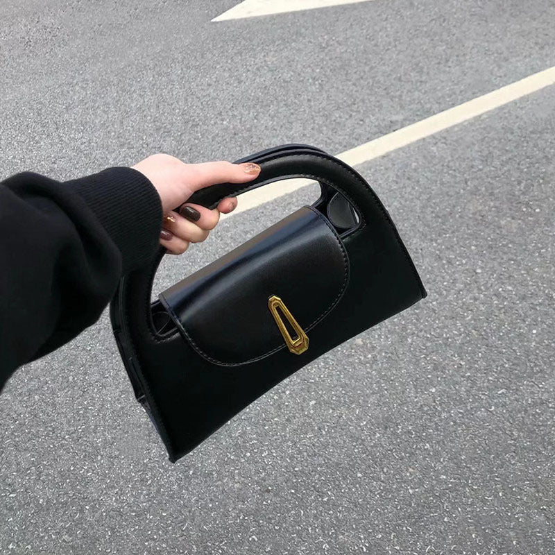 Black satchel bag with a metal button