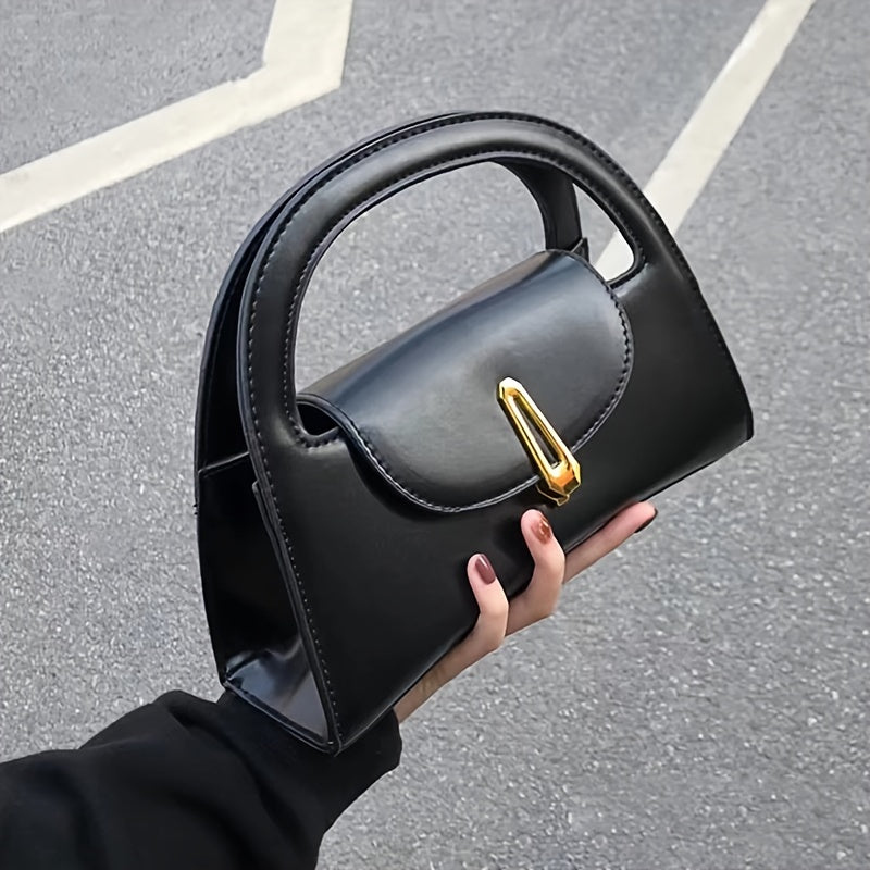 Black satchel bag with a metal button