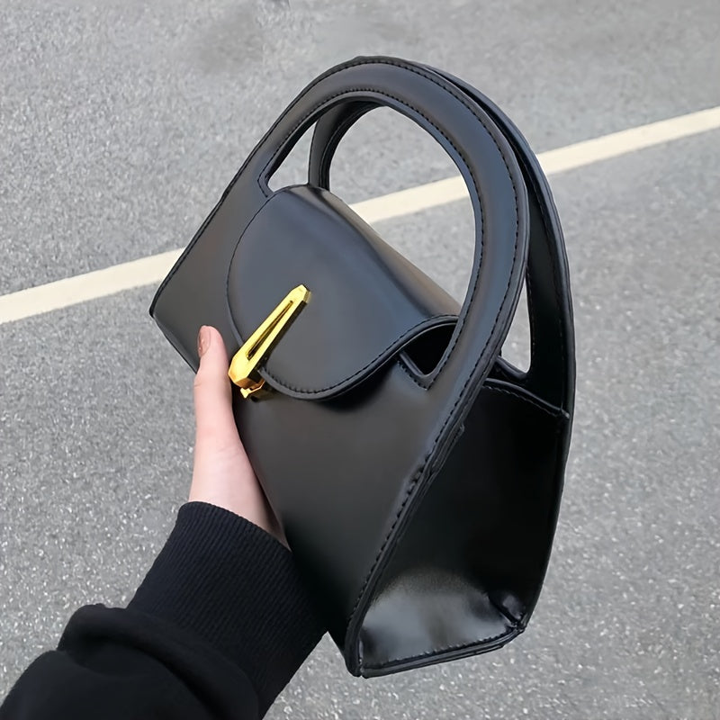 Black satchel bag with a metal button